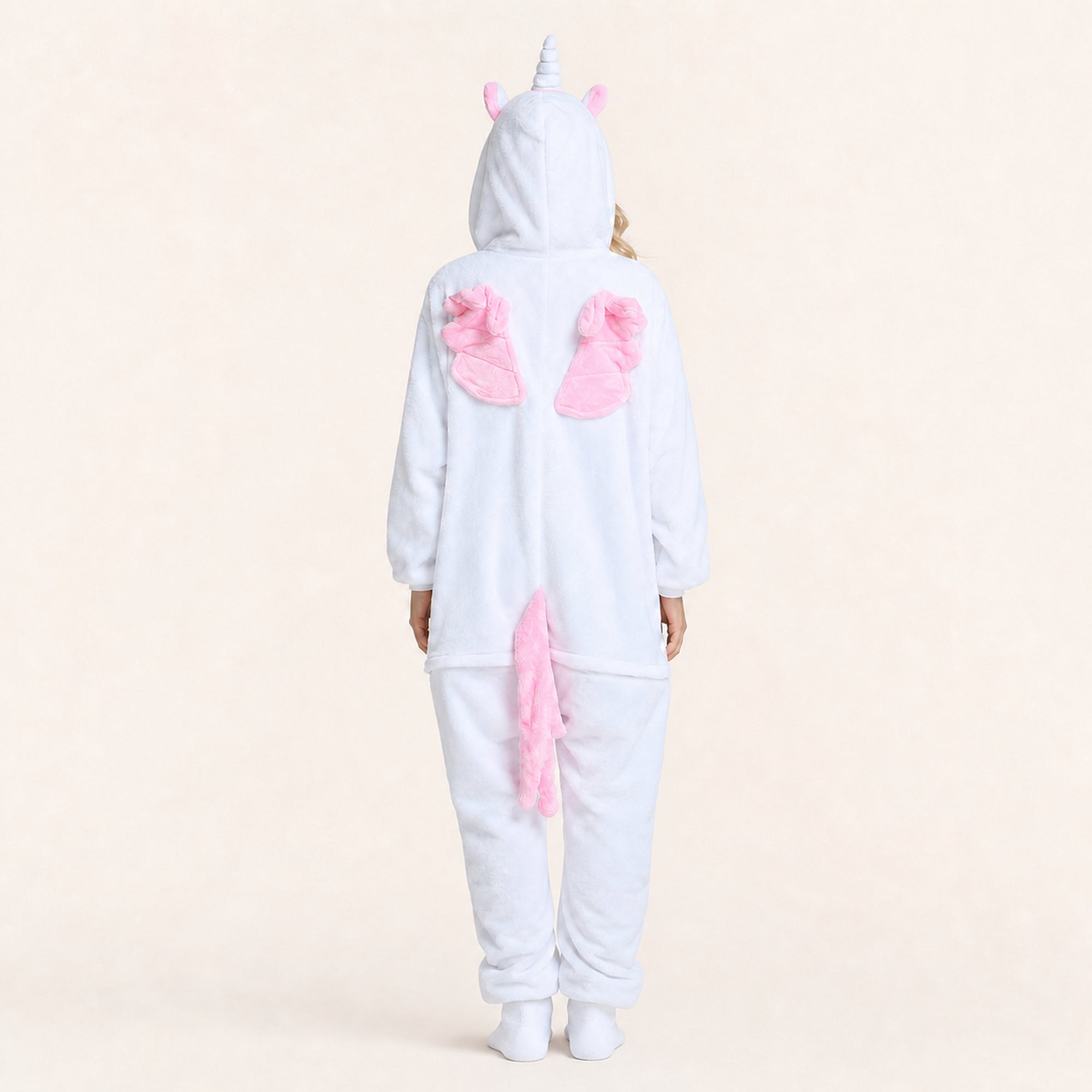 Pink wings and tail detail on white unicorn onesie